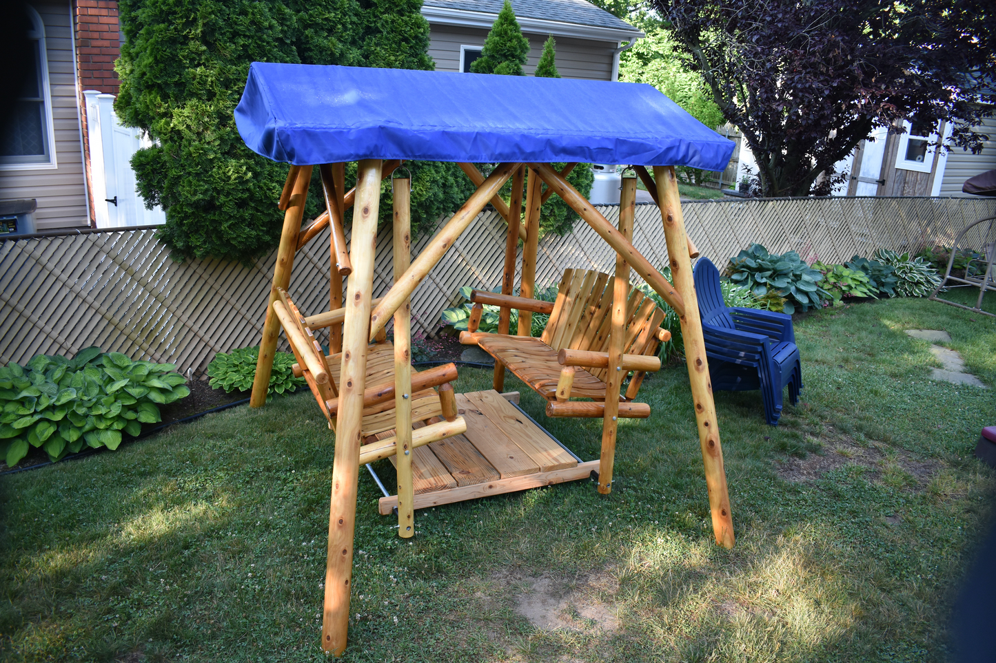 moon valley rustic outdoor cedar log double glider varnished with royal blue canopy